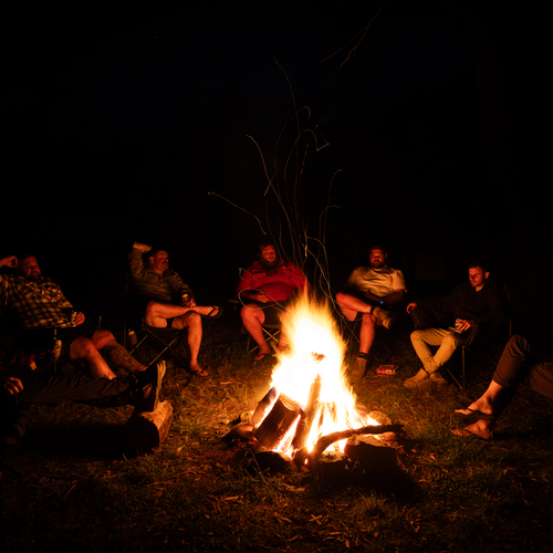 Friends around a campfire at night