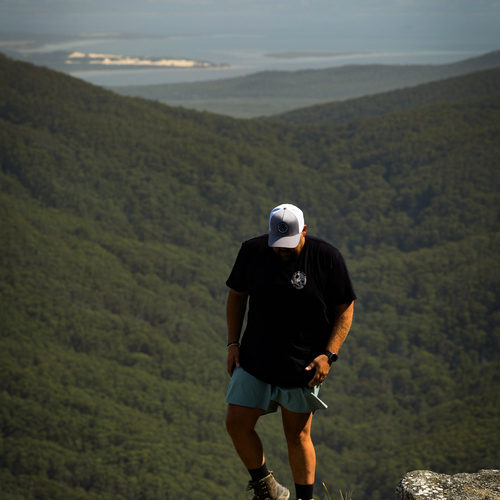 Hiker overlooking a green valley