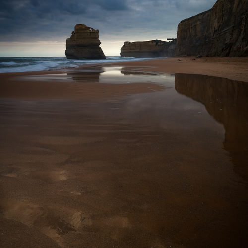 Beach at dusk with wet sand reflections